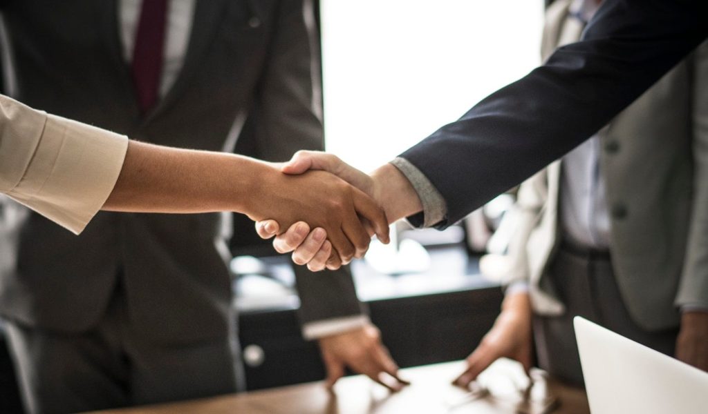 Business man and woman shaking hands