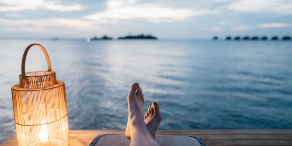 Man sitting on a lake dock